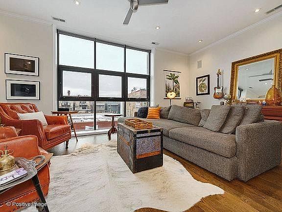 Living room with floor to ceiling windows and new wood floors.