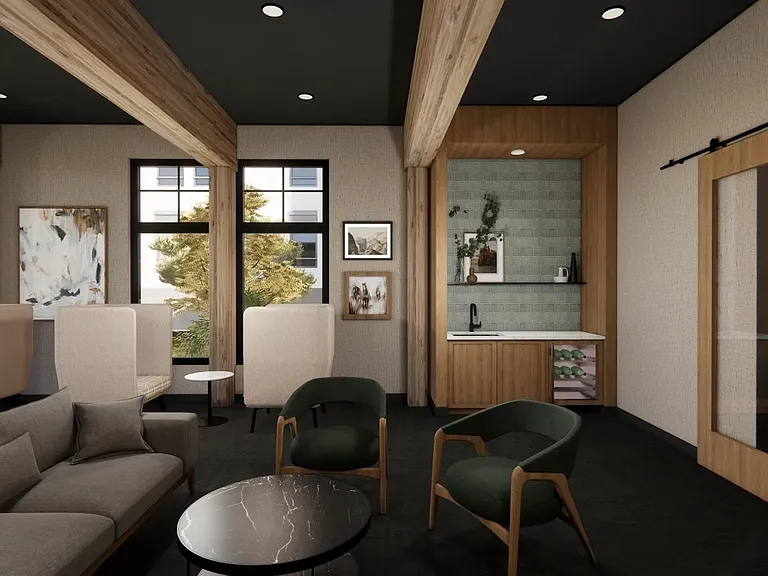Relax in the clubroom at Modera Bridle Trails, where cozy seating, a coffee bar, and wine fridge create a welcoming lounge.