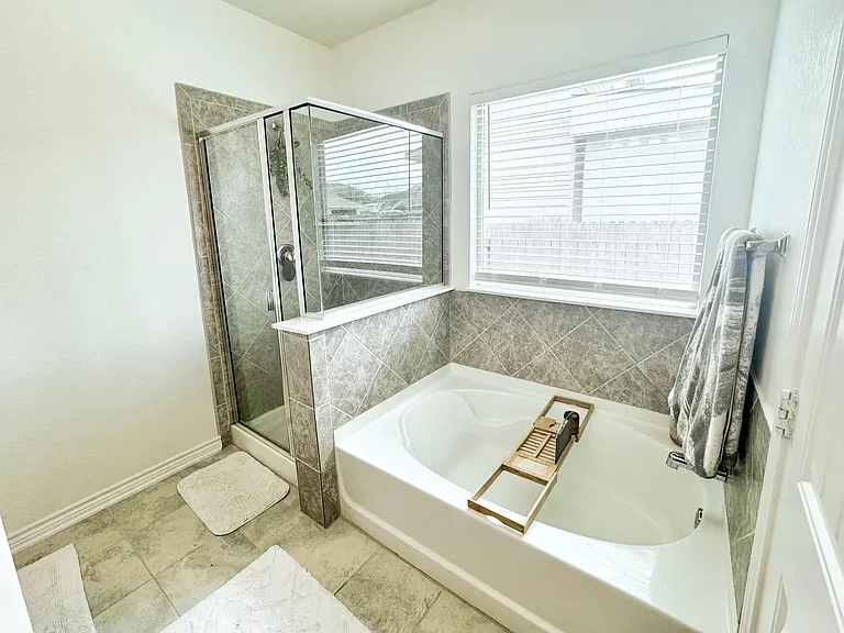 Owner's suite bathroom with garden tub and separate shower