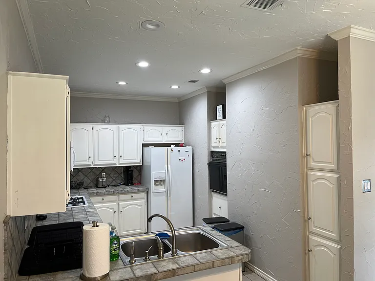 Large Kitchen with all appliances - oven, cooktop, refrigerator, microwave, & garbage disposal. Plenty of cabinet space. Shared space.