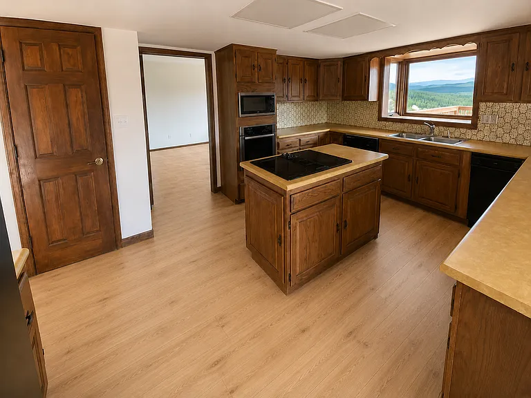Brand new Luxury Vinyl Plank flooring and large kitchen pantry. Photo is digitally altered to show flooring (original photos were taken prior to the floor install)