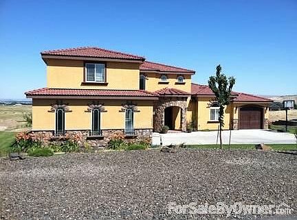 Front of the House
						:
						View of garage, and gravel on the side of the road as parking lot for visitors.