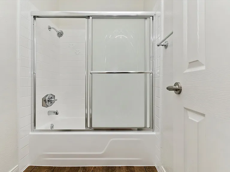 bathroom with bathtub and shower
