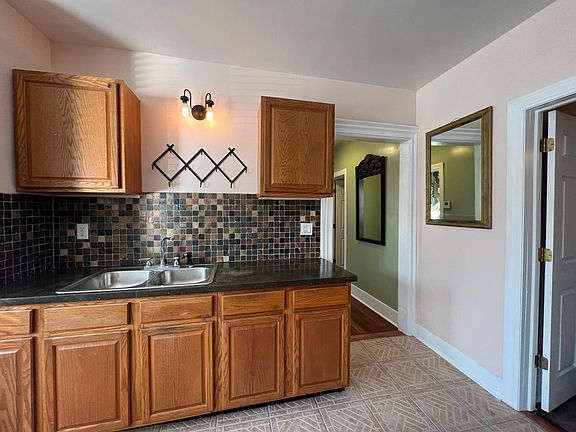 the kitchen leads to the hallway and large bedroom