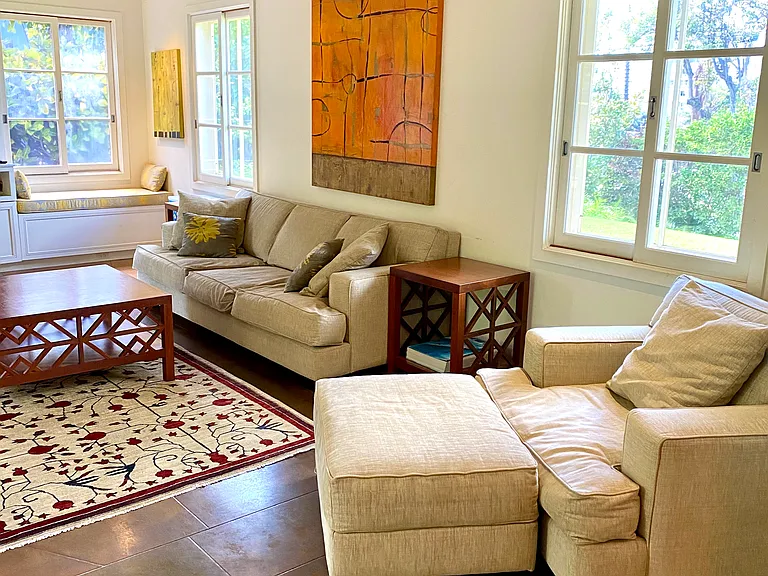 Spacious living area with tile floors that opens to a large covered lanai area.
