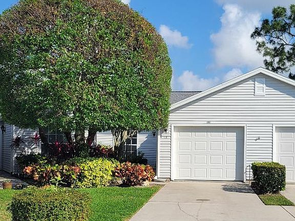 Front of the villa. You can see garage and driveway and beautiful landscaping.