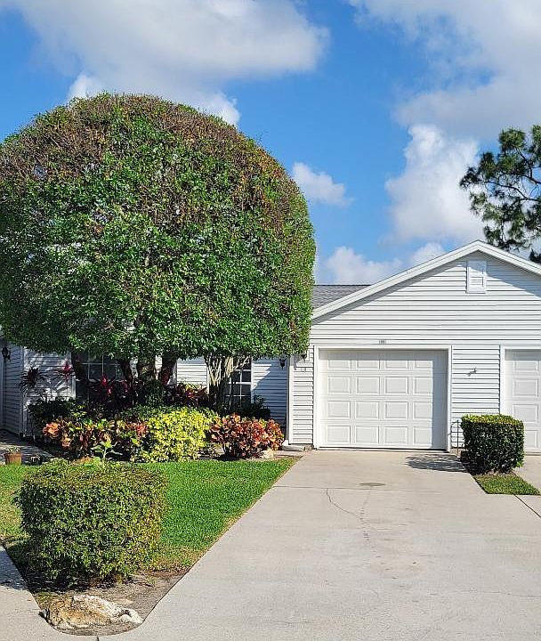Front of the villa. You can see garage and driveway and beautiful landscaping.