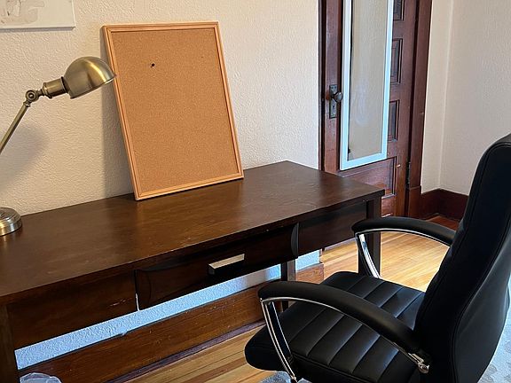 Twin bedroom with desk, closet, bed