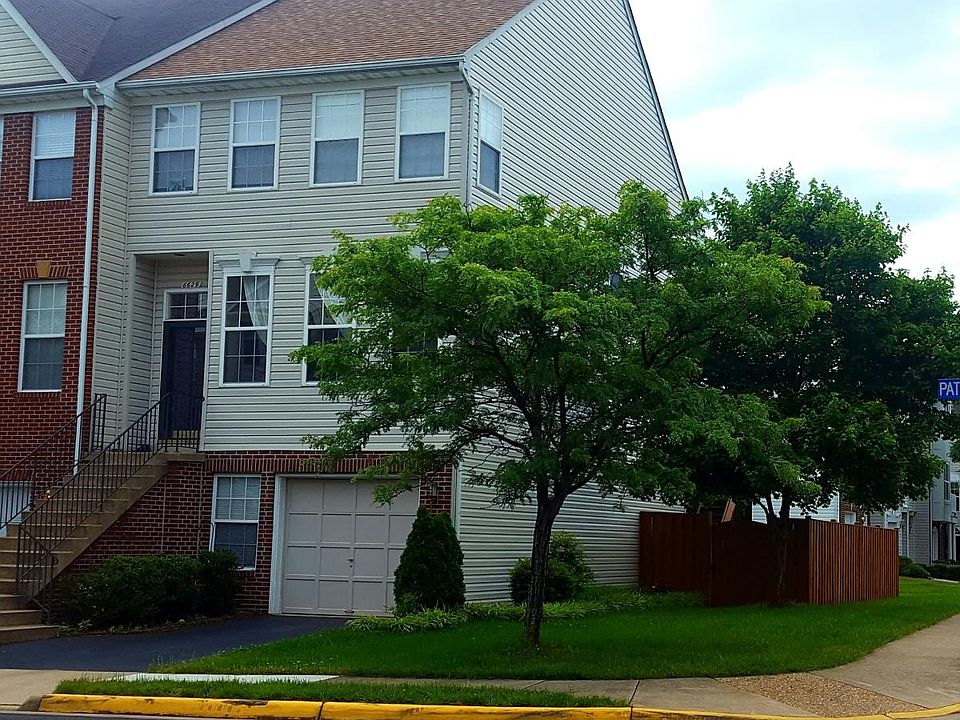 Front of house. End unit with mature trees and lots of natural light.