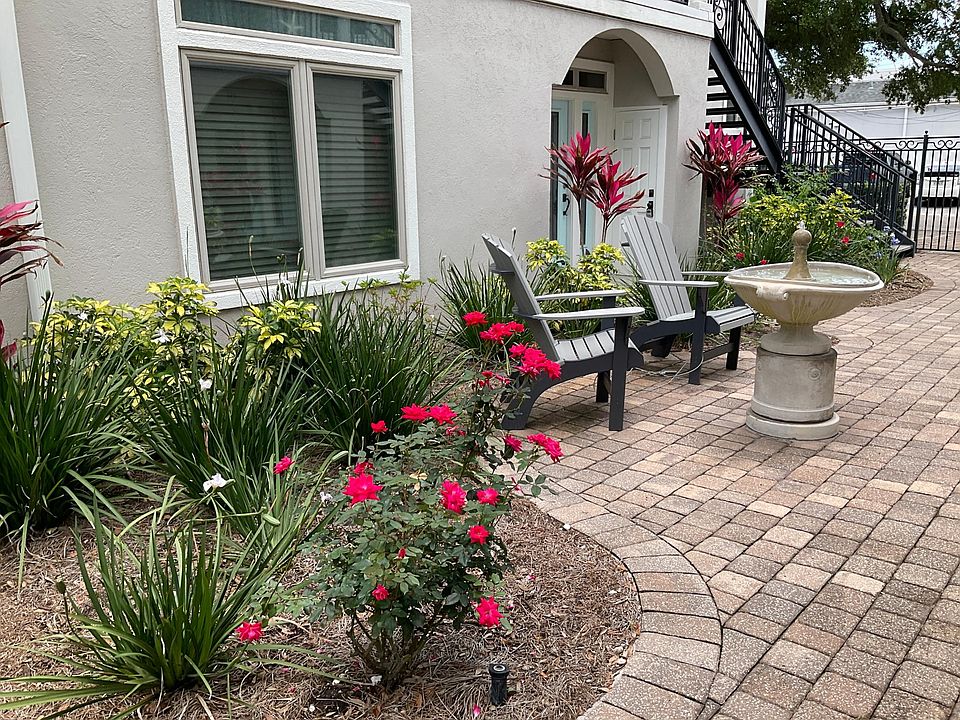 Lush garden with outdoor seating near fountain