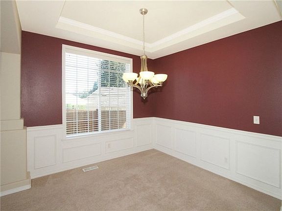 Dining room has coved ceiling and wainscoting.