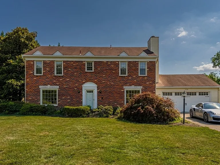 Exterior of home with two car garage and off-street parking.