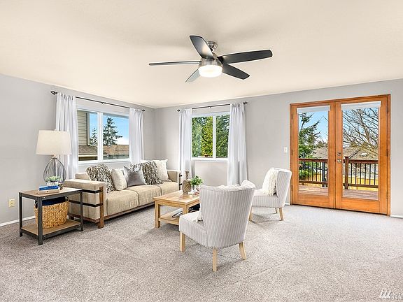Upper-level living room with double doors to entertaining deck.