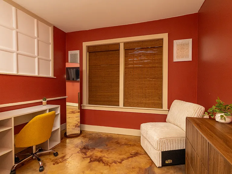Bright, stylish workspace inside the primary bedroom featuring a large desk, comfy chair, and cozy lounge area _ perfect for remote work or relaxing after a long day.