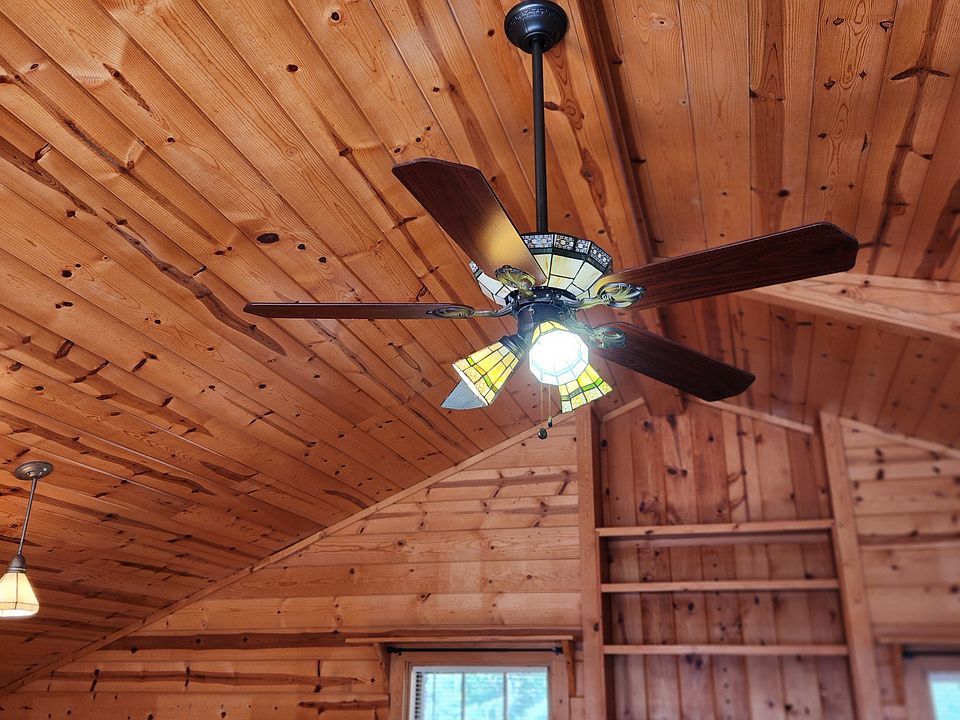 A beautiful ceiling fan and shelving grace the architecture of the home