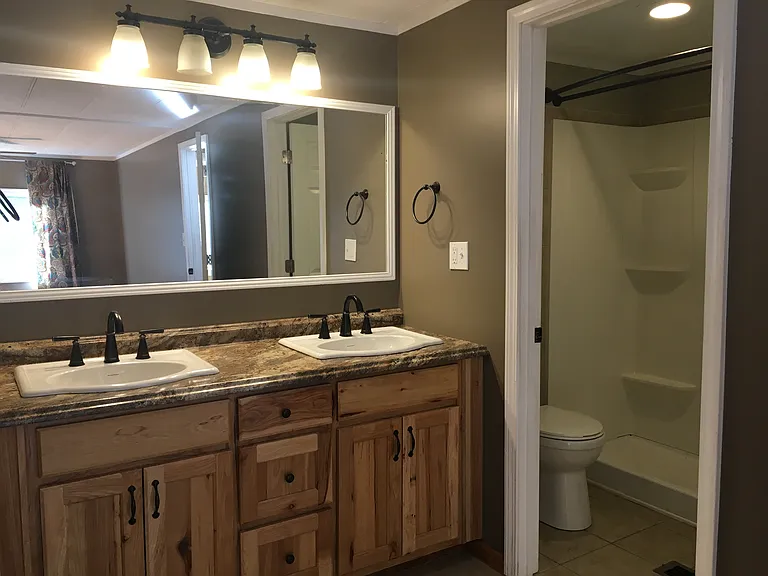 en suite bathroom to bedroom with its own outside door (end of house closest to driveway), with shower and separate vanity