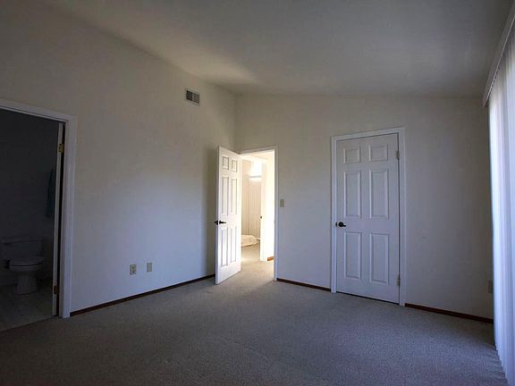 Master bedroom with walk in closet and balcony.