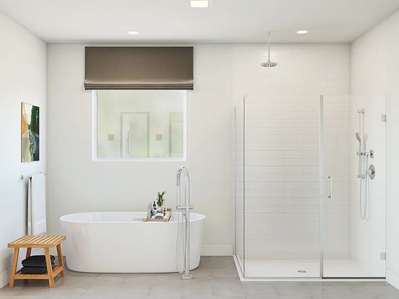 Primary bath with freestanding tub and glass shower enclosure