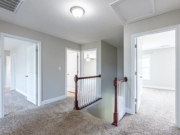 Upstairs landing providing access to all upper-level rooms and a closet for additional storage
