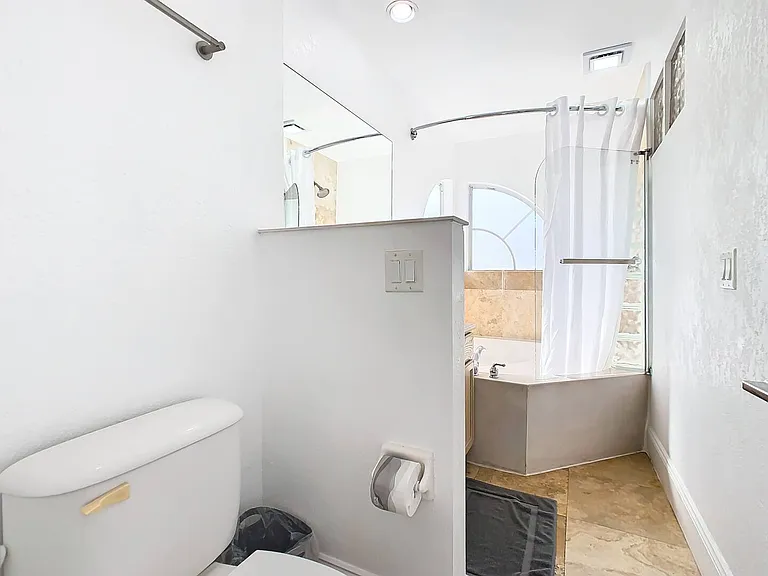 Experience the luxury of a Jacuzzi tub and shower combo, enhancing your stay with lavish amenities.