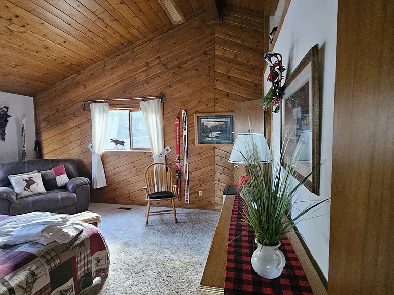 Different angle of bedroom. Decorated in lodge style. Directly off of 3rd floor front room. Fully furnished for the traveling man. Large walk in closet.