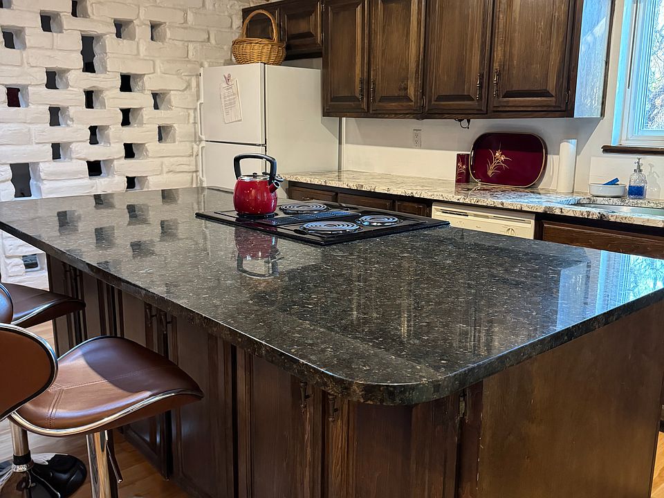 Large granite island. Plenty of room for cooking and entertaining! Open kitchen and den area.