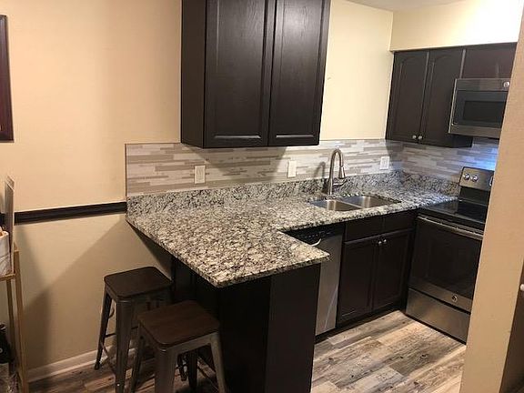 Remodeled kitchen with granite countertops, tile backsplash, S.S. appliances, new and/or freshly repainted cabinets.