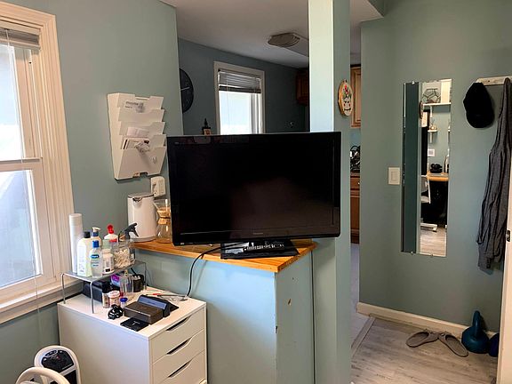 TV on counter that has drawer and cabinets on other side - also good location to set up a coffee bar