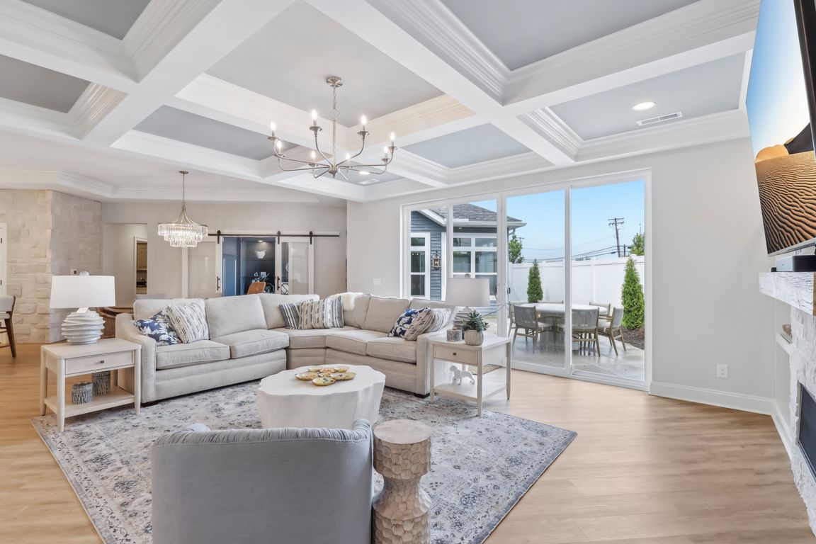 Spacious living room w/ sliders to private patio, letting in plenty of natural light