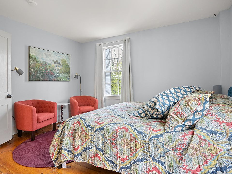 Bright and inviting, this king bedroom offers bold comfort, cozy seating, and a restful view_perfect for lazy winter mornings.