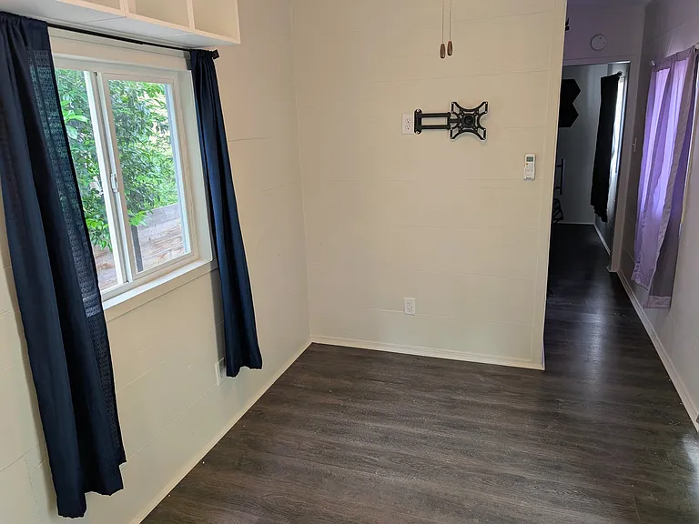 Living area with lots of natural lighting. Space for a small couch and table.