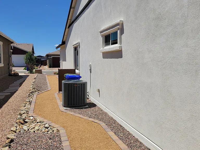 Side yard and trash can area