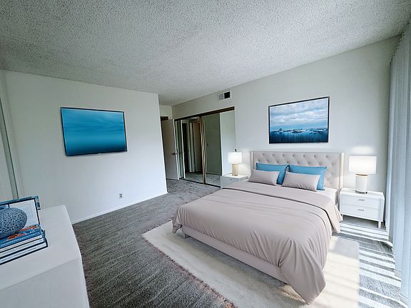 Primary bedroom is quite spacious with mirror closet doors, new paint and carpet. Step out to the patio through glass slider doors. NOTE: Bedroom was virtually staged.