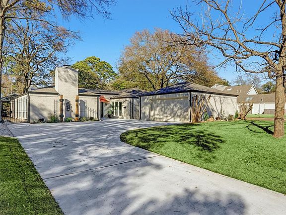 As you drive up and see the Amazing Exterior of this Home it Is Apparent No Detail Has Been Overlooked! Completely Remodeled Inside And Out, here we see the New Driveway that Includes Additional Parking Pad, Totally New Landscaping Including Gorgeous