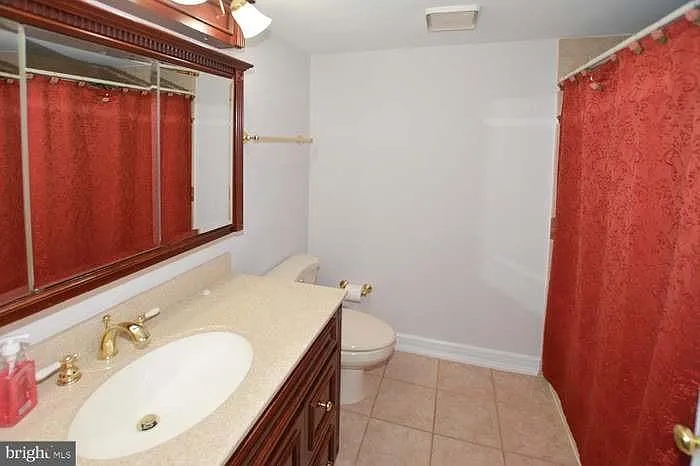 Hallway bathroom with bathtub.