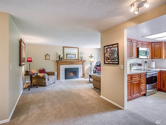 You enter into the home's center - the welcoming living room is adjacent to the beautifully remodeled Kitchen 