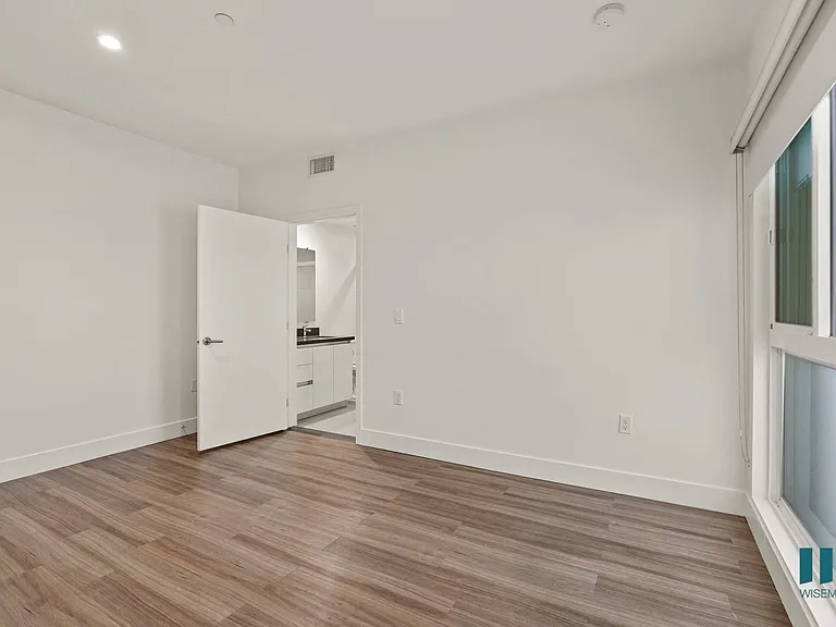 Bedroom with Large Windows, Recessed Lighting, and Vinyl Flooring