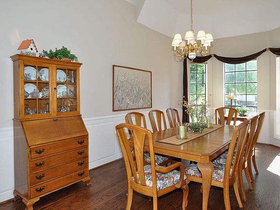 Elegant formal dining with hard wood floors and gorgeous bay windows