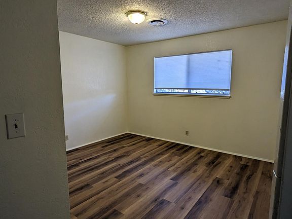 Bedroom with closet. New flooring and fresh paint on all walls and new shades.