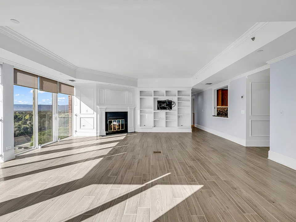 Living Room with fireplace and built-in shelving. TV bracket included.