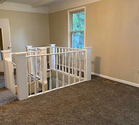 Living room with stairs to basement room