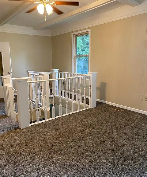 Living room with stairs to basement room
