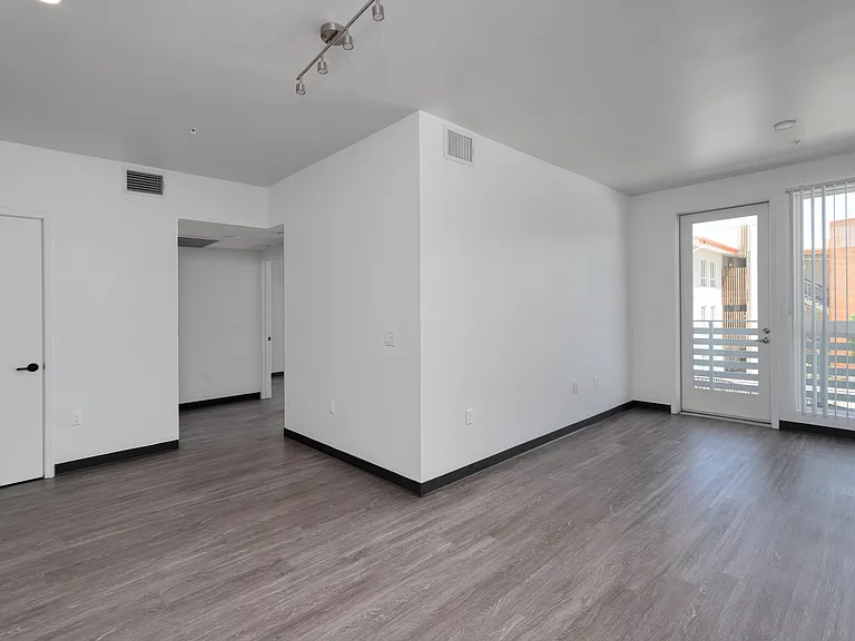 Bright living space with private balcony access and flexible layout.