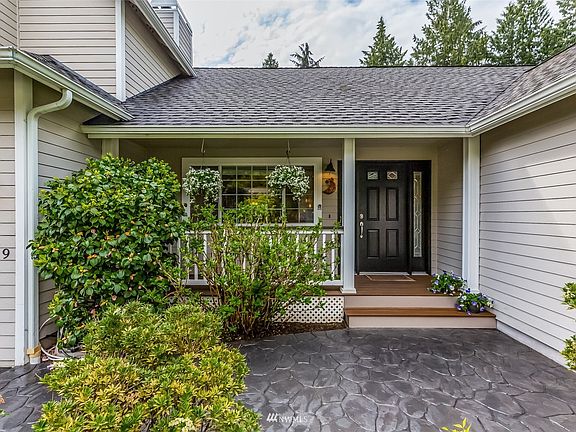 Stamped concrete leads to the welcoming covered front porch.