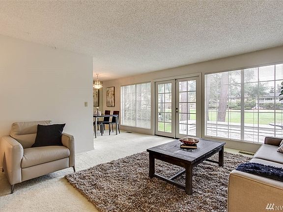 Gatherings will be a delight both inside and out with these lovely french doors and a wall of windows. 