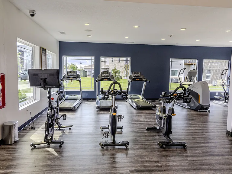 The fitness center is equipped for full-body workouts, including a Peloton bike.
