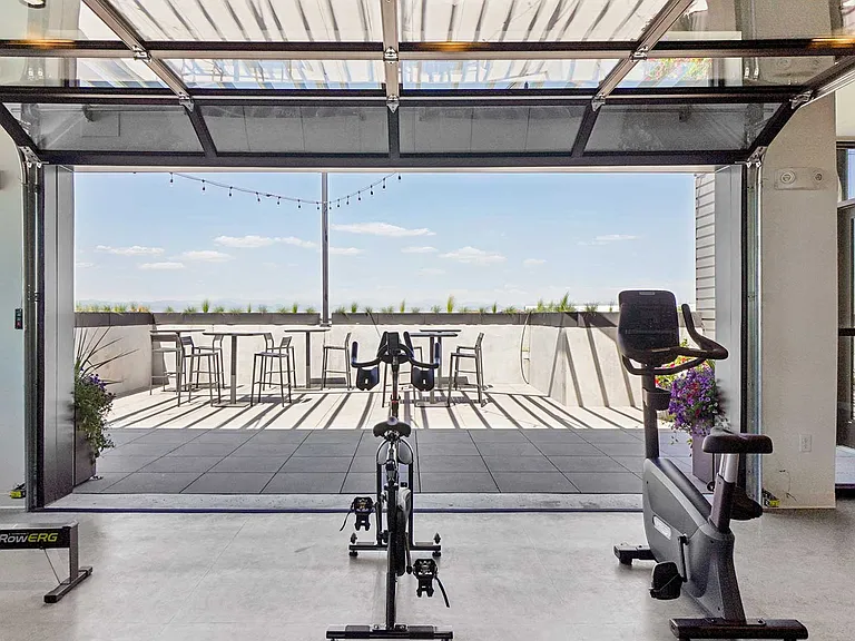 Enjoy a seamless indoor-outdoor workout experience with rooftop access, open-air seating, and modern cardio equipment.