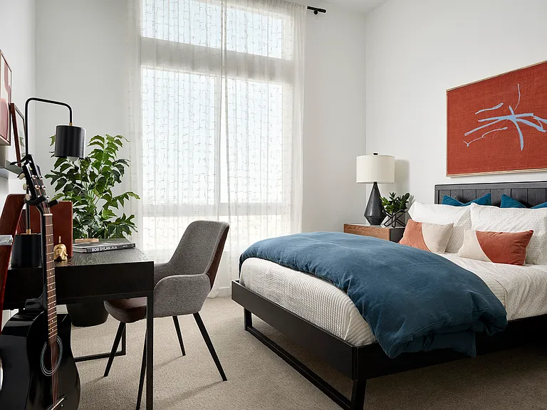 B934: Bedroom with desk and guitar