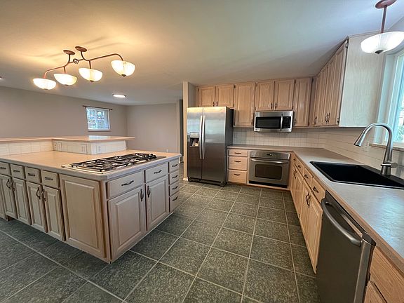 Kitchen with stainless steel appliances and 5-burner gas cooktop