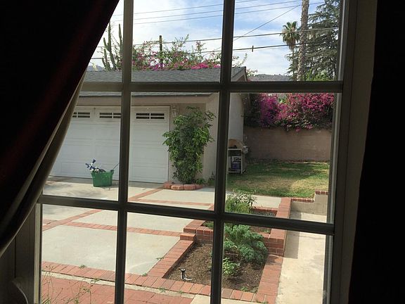 View of back yard through French sliders in Master BD